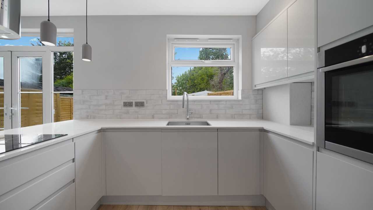 Contemporary fitted kitchen with integrated appliances in Harrow family home listed by Empire Chase.