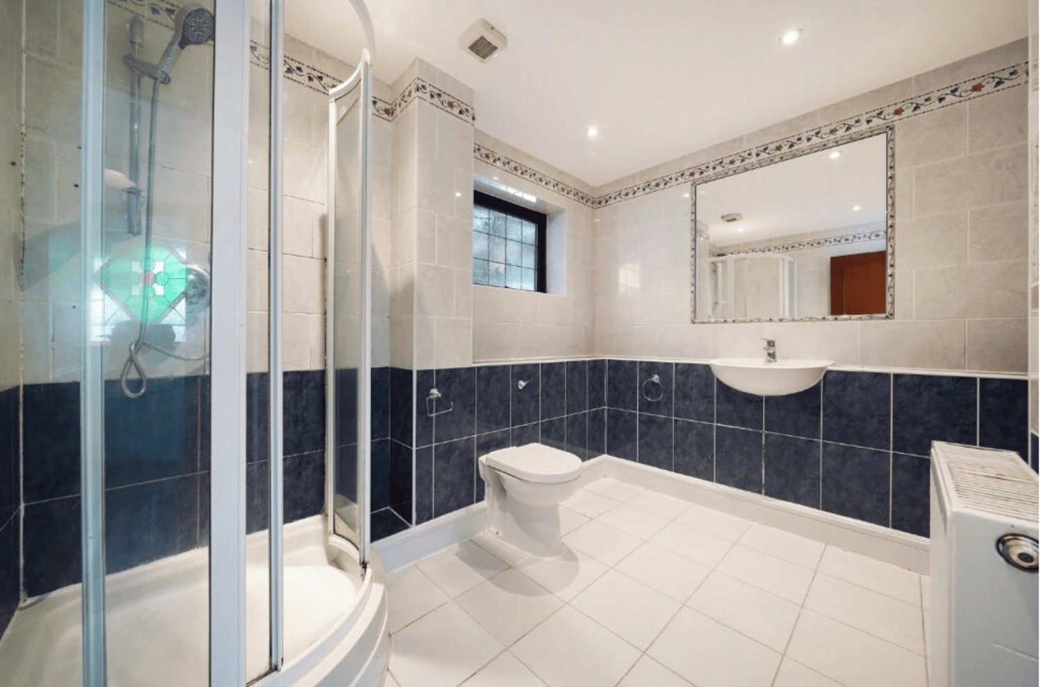 Modern shower room with tiled walls and glass enclosure in Cheney Street HA5 property.
