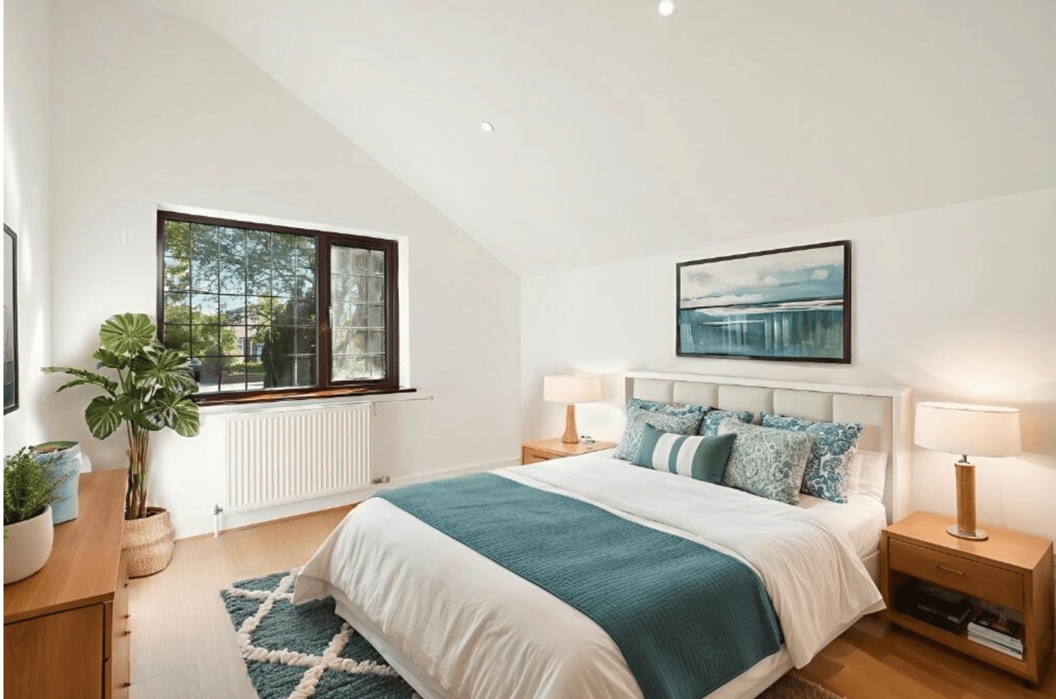 Bright double bedroom with wooden furniture and large window in Cheney Street HA5 home.