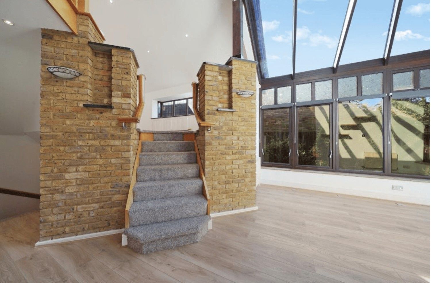 Internal staircase with brick pillars and glass extension roof in Cheney Street HA5 detached property.