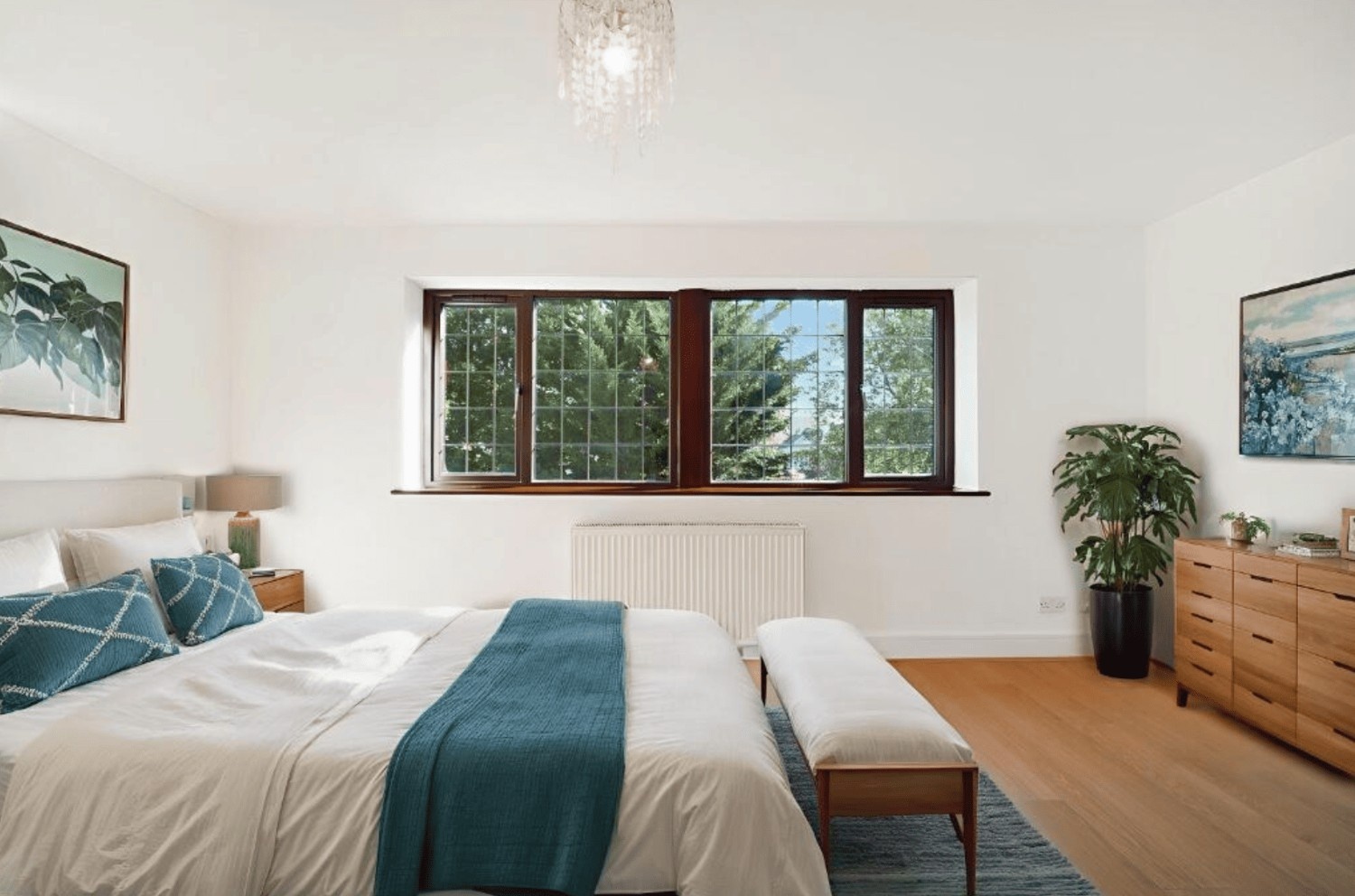 Spacious master bedroom with large window and wooden flooring in Cheney Street HA5 property.